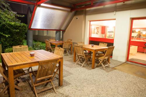 a group of tables and chairs in a restaurant at ClassEco Gent in Ghent