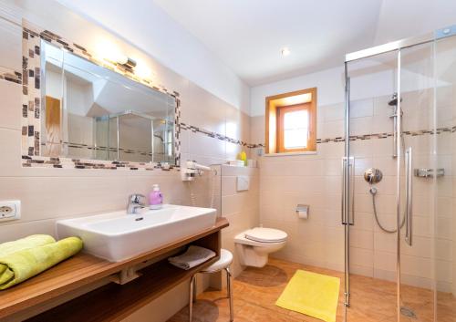 a bathroom with a sink and a shower at Appartement Pension Albert summercard and free parking included in Zell am See