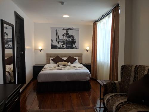 a hotel room with a bed and a chair at Air Suites Hotel Boutique in Quito