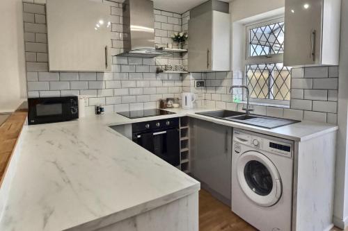 a white kitchen with a washing machine in it at 52 Minster in Beverley