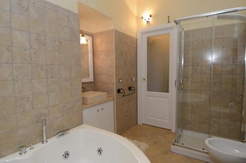 uma casa de banho com uma banheira, um lavatório e um chuveiro em Residenza Casale San Francesco em Tropea