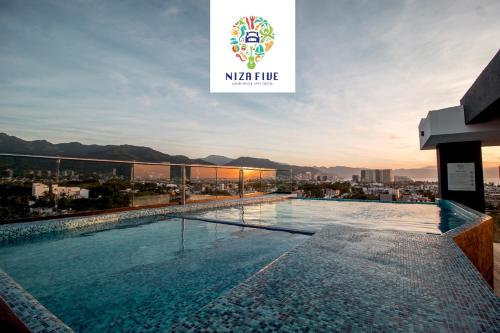 a swimming pool on the roof of a building at NIZA FIVE Luxury Beach Apartments in Puerto Vallarta