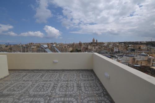 a balcony with a view of a city at The Penthouse Flat-terrace&view in Senglea