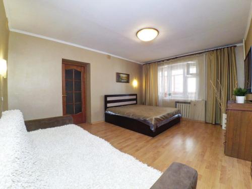 a bedroom with two beds and a window at Apartment Grand Kazan on Chetaeva 28 in Kazan