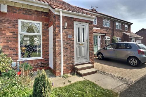 a car parked in front of a brick house at 52 Minster in Beverley