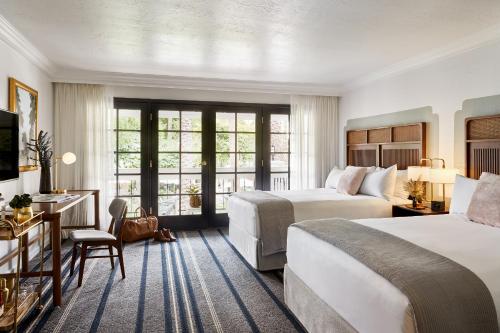 a hotel room with two beds and a desk at The Scott Resort & Spa in Scottsdale