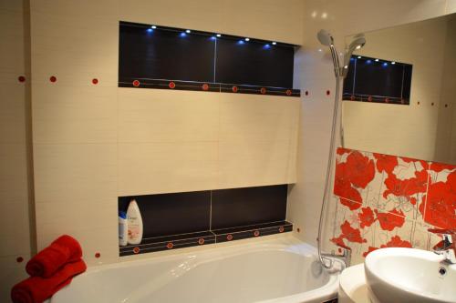 a bathroom with a white tub and a sink at U Hanusi in Ostróda