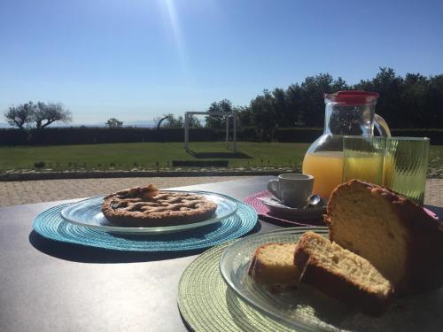 a table with two plates of bread and a bottle of orange juice at PARCO DELLE STELLE in Castelmauro