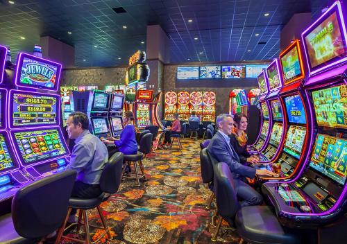 a group of people playing slot machines in a casino at Swinomish Casino & Lodge in Anacortes