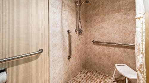 a bathroom with a shower with a toilet at Lompoc Valley Inn and Suites in Lompoc