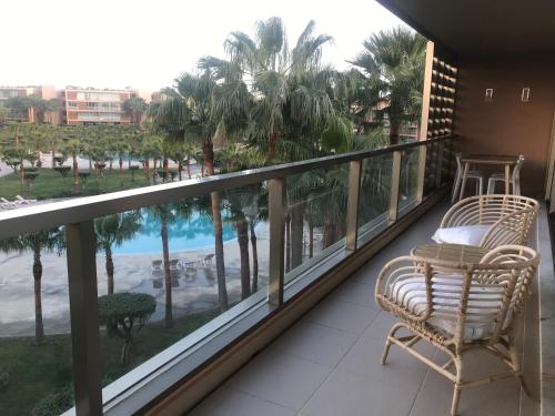 a balcony with a chair and a view of the beach at Salgados Beach Apartment 6A in Albufeira