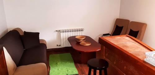 a room with a couch and a table and a stool at PEGAZOWA WOLA CISNA in Cisna