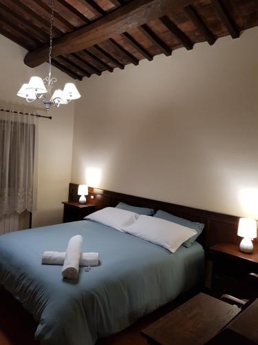 Ένα ή περισσότερα κρεβάτια σε δωμάτιο στο Agriturismo Il Pappamerlo