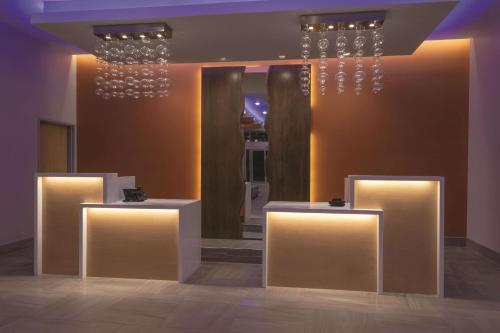 a room with three tables with lights on them at La Quinta by Wyndham South Jordan in South Jordan