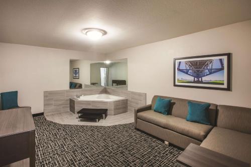 a living room with a couch and a tub at La Quinta by Wyndham Walker - Denham Springs in Walker