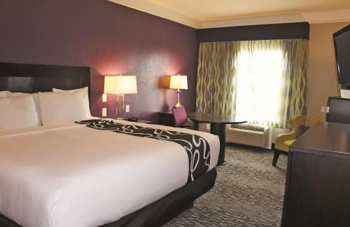 a hotel room with a large bed and a window at La Quinta by Wyndham Pearland in Pearland
