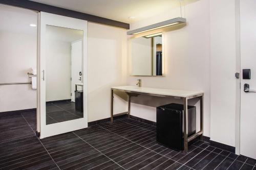 a bathroom with a sink and a mirror at La Quinta by Wyndham Winchester in Winchester