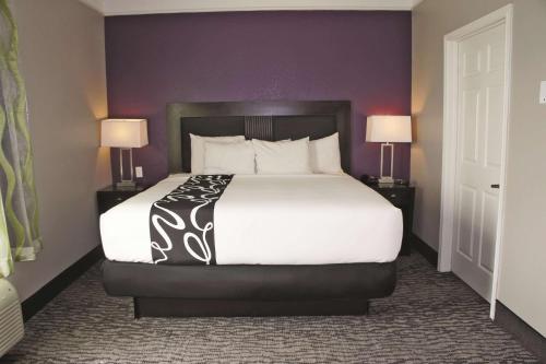 a large bed in a hotel room with two lamps at La Quinta by Wyndham Pearland in Pearland
