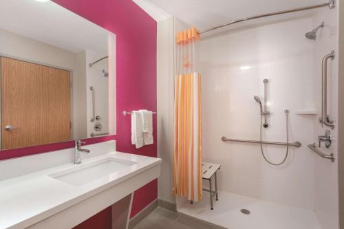 a bathroom with a sink and a shower at La Quinta by Wyndham South Jordan in South Jordan