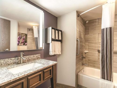 a bathroom with a sink and a tub and a shower at La Quinta by Wyndham Glenwood Springs in Glenwood Springs