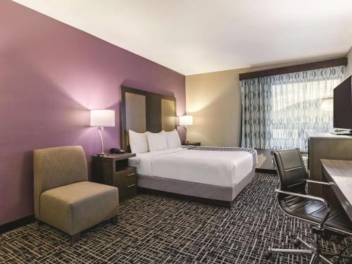 a hotel room with a bed and a chair at La Quinta by Wyndham Glenwood Springs in Glenwood Springs