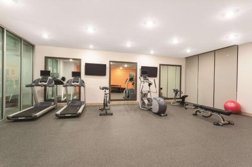 a gym with treadmills and cardio equipment in a room at La Quinta by Wyndham South Jordan in South Jordan