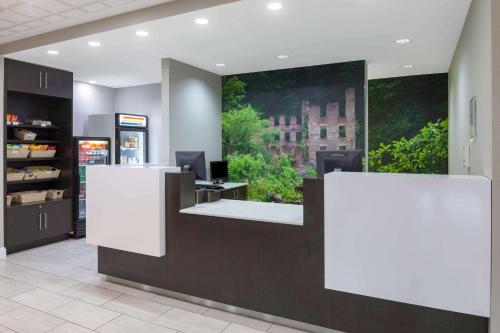 a lobby of a store with two white counters at La Quinta by Wyndham Atlanta Douglasville in Douglasville