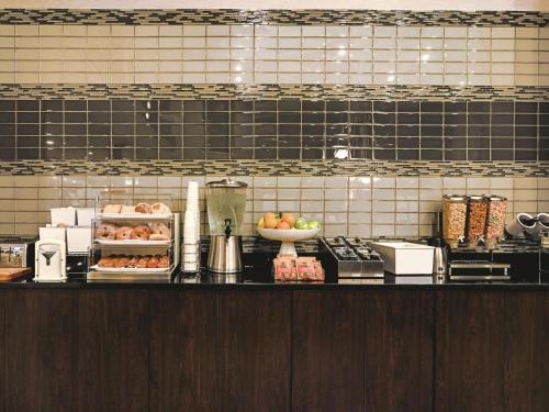 a kitchen with a counter with food on it at La Quinta by Wyndham Denver Airport DIA in Denver