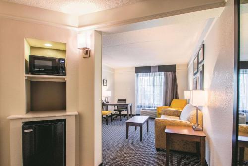 a hotel suite with a living room and dining room at La Quinta by Wyndham Orem University Pwy Provo in Orem