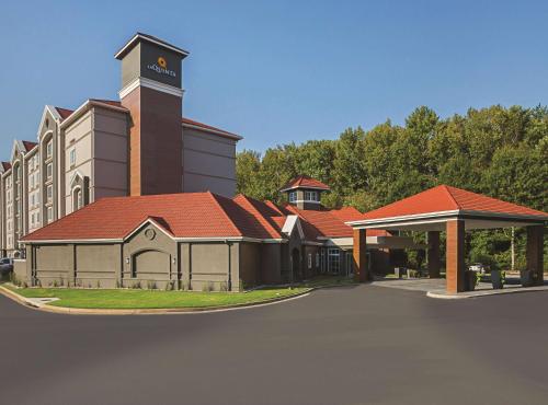 a rendering of a building with a clock tower at La Quinta by Wyndham Atlanta Alpharetta in Alpharetta