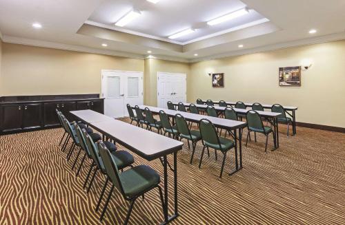 a conference room with tables and chairs in it at La Quinta by Wyndham Pearland in Pearland