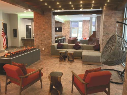 a lobby with a couch and chairs and a fireplace at La Quinta by Wyndham New Orleans Downtown in New Orleans