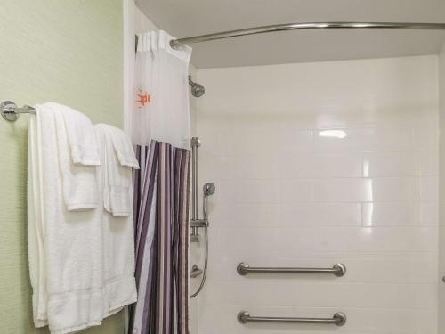 a shower in a bathroom with white towels at La Quinta by Wyndham New Orleans Downtown in New Orleans