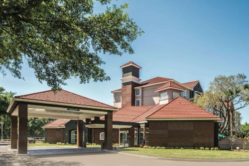 a building with a clock tower on top of it at La Quinta by Wyndham Orlando Lake Mary in Lake Mary