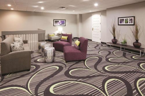 a waiting room with couches and chairs on a carpet at La Quinta by Wyndham Minneapolis Bloomington W - FREE AIRPORT SHUTTLE in Bloomington