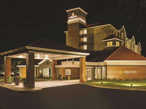 a large building with a clock tower at night at La Quinta by Wyndham Atlanta Alpharetta in Alpharetta