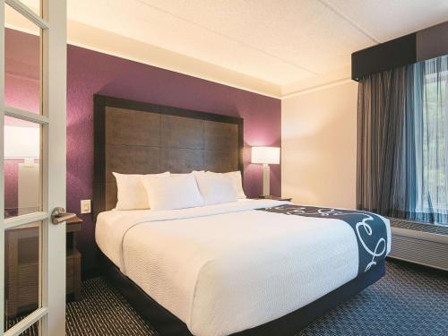 a hotel room with a large bed and a window at La Quinta by Wyndham Atlanta Conyers in Conyers