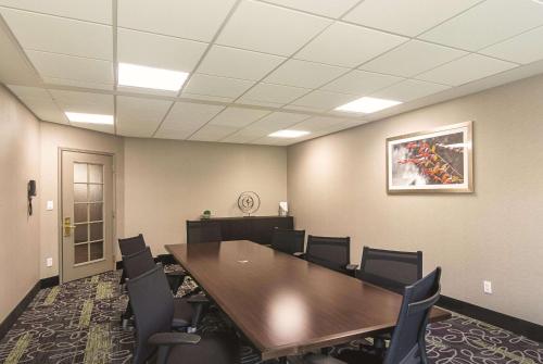 a conference room with a wooden table and chairs at La Quinta by Wyndham Oklahoma City Norman in Norman