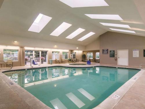 a large swimming pool in a hotel lobby at La Quinta by Wyndham Denver Airport DIA in Denver