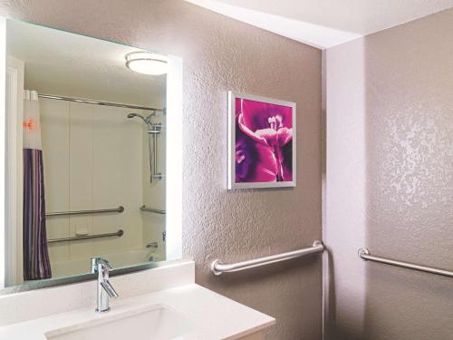 a bathroom with a sink and a mirror at La Quinta by Wyndham Denver Airport DIA in Denver
