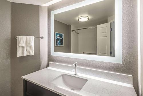 a bathroom with a sink and a mirror at La Quinta by Wyndham Orlando Lake Mary in Lake Mary