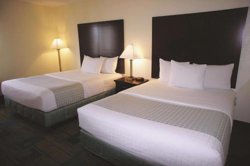 a hotel room with two beds and two lamps at La Quinta by Wyndham Boston Somerville in Somerville