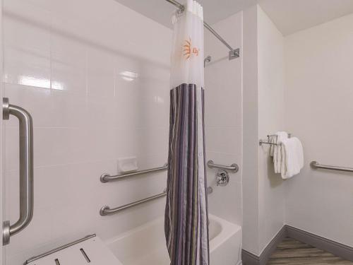 a bathroom with a shower with a shower curtain at La Quinta by Wyndham Austin Round Rock in Round Rock