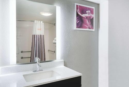 a bathroom with a sink and a mirror at La Quinta by Wyndham Rancho Cordova Sacramento in Rancho Cordova