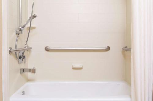 a bathroom with a tub and a shower curtain at La Quinta Inn by Wyndham Austin North in Austin