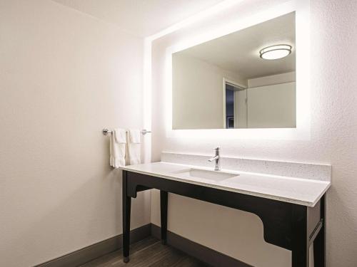 a bathroom with a sink and a mirror at La Quinta by Wyndham Baltimore N / White Marsh in Baltimore