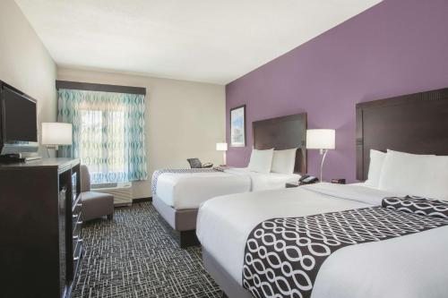 a hotel room with two beds and a television at La Quinta by Wyndham Fort Walton Beach in Fort Walton Beach