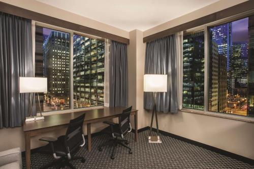 an office with a desk and a view of the city at La Quinta by Wyndham Chicago Downtown in Chicago
