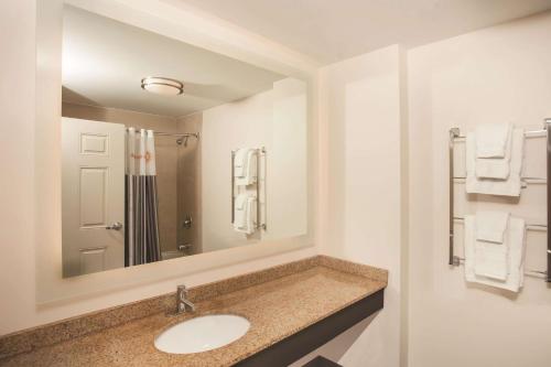 a bathroom with a sink and a mirror at La Quinta by Wyndham Chicago Downtown in Chicago