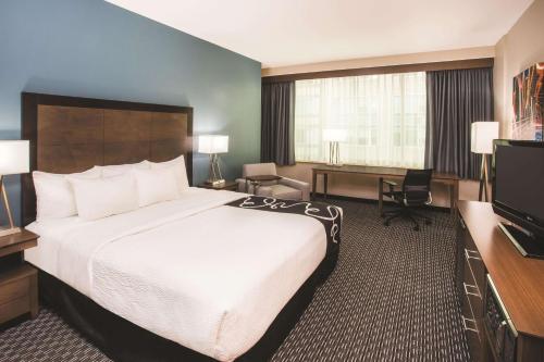 a hotel room with a large bed and a television at La Quinta by Wyndham Chicago Downtown in Chicago